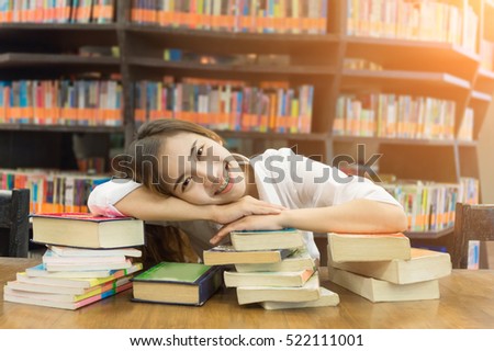 Soft focus female student smiling in a high school library. Blurred background.