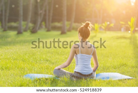 Yoga in the park, outdoor with effect light, health woman, Yoga woman. Concept of healthy lifestyle and relaxation.