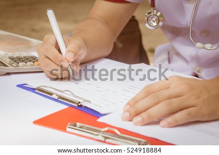 Health care costs concept picture : Stethoscope and calculator on a medical chart ,symbol for health care costs or medical insurance in tone.