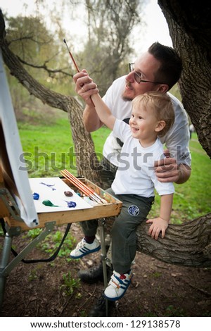 Dad and son paint colors in the park