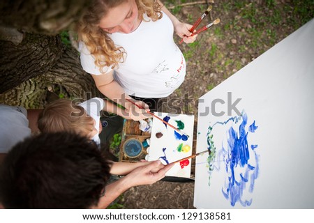 Family draws paints in a park
