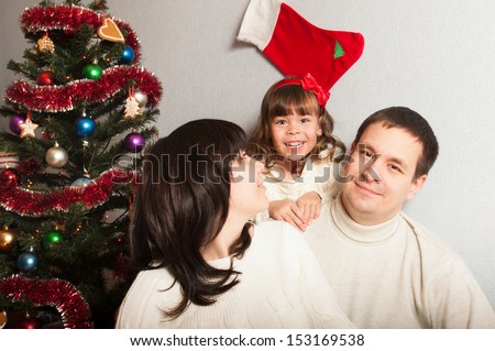 Happy family near the Christmas tree