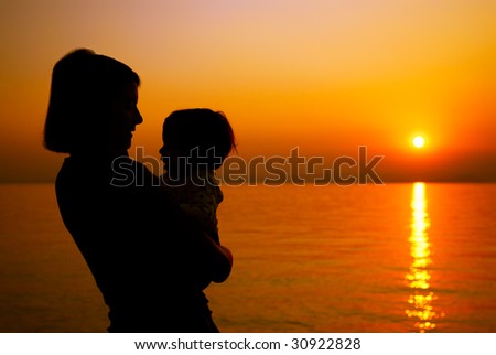Mother and child silhouette at the sunset