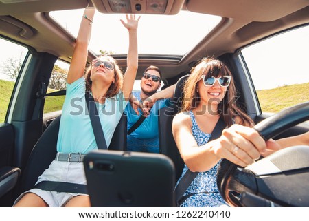 group of people having fun in road trip. car travel concept