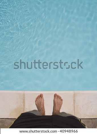 standing at the edge of a swimming pool. about to jump in. great for copy-text.