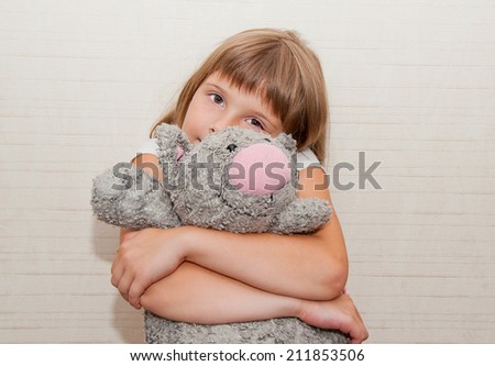 Girl dreaming with grey plush toy cat