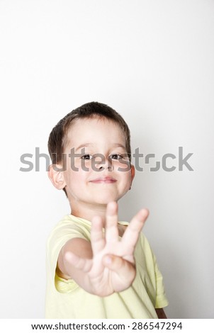 portrait of a boy with his hands up