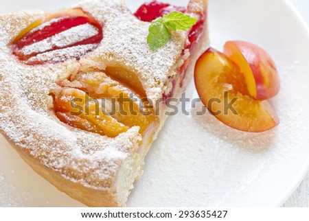 Pie with plums in powdered sugar.selective focus