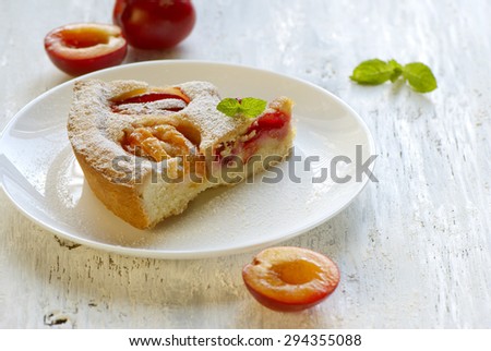 Pie with plums in powdered sugar.
