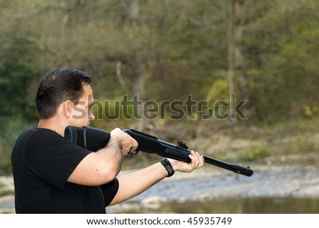 Portrait of a hunter shooting.  Air rifle