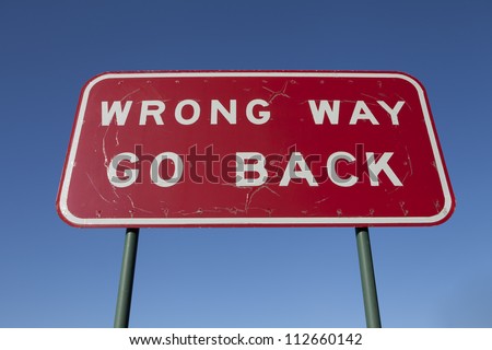 Wrong way go back road sign.