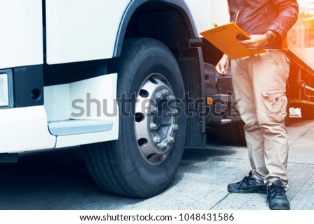 Daily inspection, Driver man hand holding clipboard with checking safety of a truck.