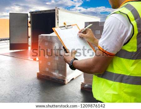 Logistic and warehouse. Warehouse loader are holding a clipboard with checking the shipment pallet for loading into a truck.