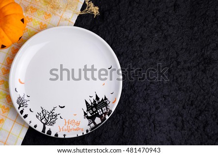 Top view of blank halloween plate on black background, with blank space and decorated.