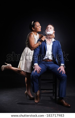 Beautiful asian woman is helping to shaving man