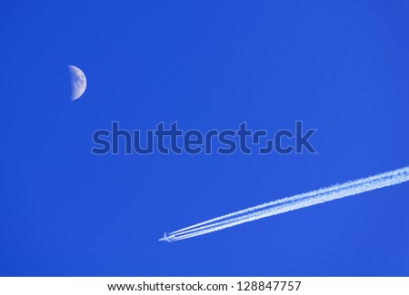 Blue Sky, Moon and Jet Aircraft with Condensation (Vapor) Trail