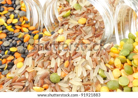 Assorted Cereals Spilling Out of Glass Jars