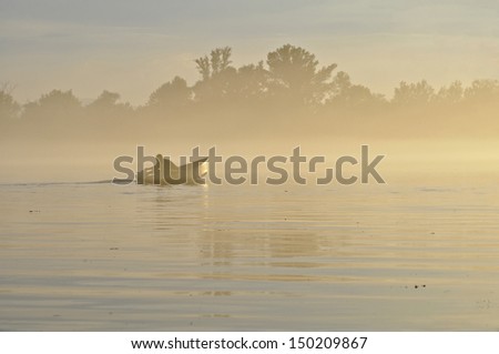 man on the river in the fog