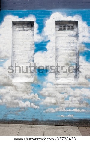 Graffiti clouds on brick wall