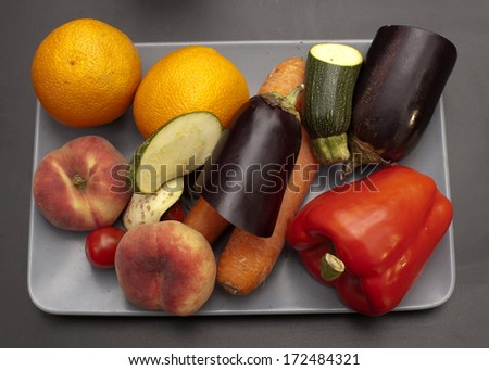 Assorted grocery products including vegetables fruits wine bread dairy and meat  products on the kitchen table vegetables on a kitchen table