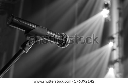 microphone on the stage and empty hall during the rehearsal black and white photo
