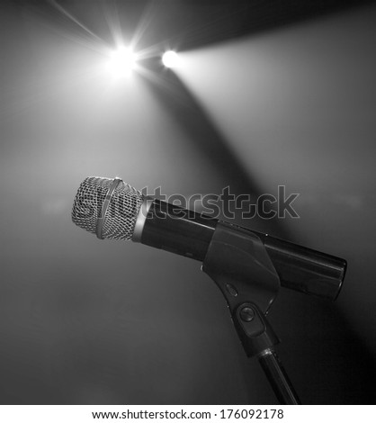 microphone on the stage and empty hall during the rehearsal black and white photo