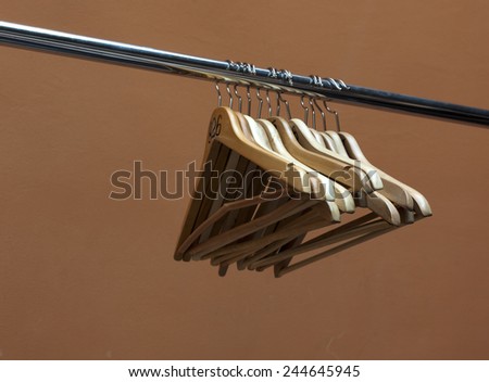Clothes hanger hanging on rod close up   wooden hangers