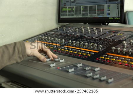 sound studio adjusting record equipment\
console sound engineer