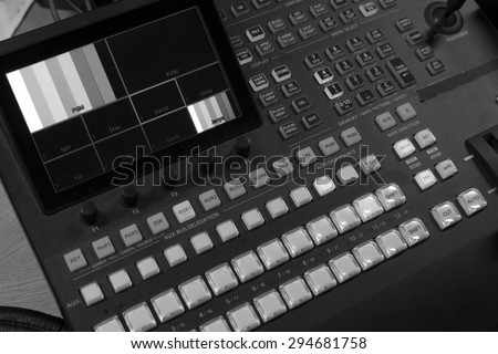 button on the control panel television equipment. black and white photo