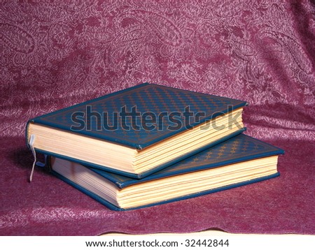 Books Lying on Purple Cloth