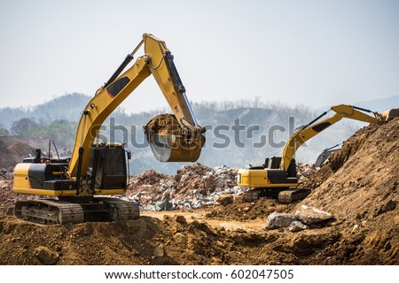 Working hydraulic excavators in the mine.\
Working in mining industry. Mining activities. Mine operations. Quarry Operations.