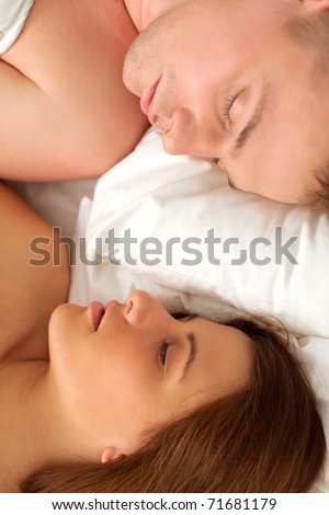 Loving man and woman sleep in their bedroom