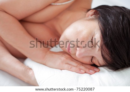 Tired lady sleeping in her white bed