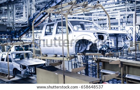 Modern automatic automobile manufacturing workshop. A busy car production line. Industrial scenery background.