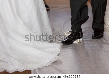 Groom breaking a glass at a Jewish wedding stamping it underfoot symbolizing the destruction of the temple in Jerusalem, close up of the right foot