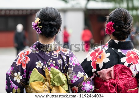 Young girl wearing Japanese kimono standing in front of Sensoji Temple in Tokyo, Japan. Kimono is a Japanese traditional garment. The word \
