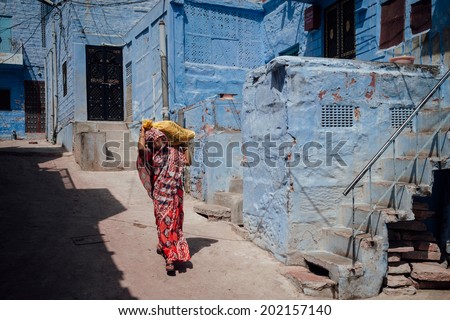 SHAPURA - MARCH 12 : woman walking on the street on March 12 , 2014 in Shapura,India