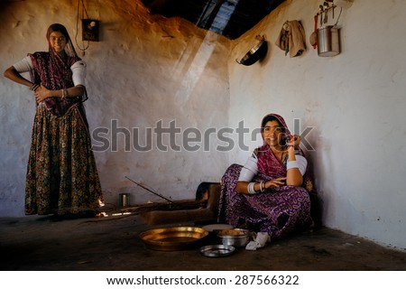 JAISALMER - MARCH 20 : women preparing food in mud hut on March 20 , 2014 in Jaisalmer,India
