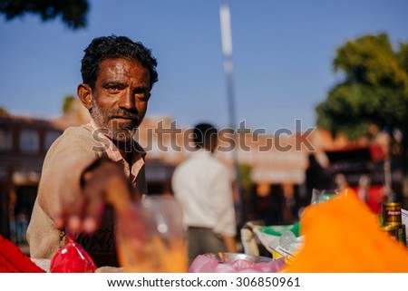 JAIPUR, INDI-MARCH 04 :man selling colourful powder for religious celebration in the street on March 04, 2014 in Jaipur,india