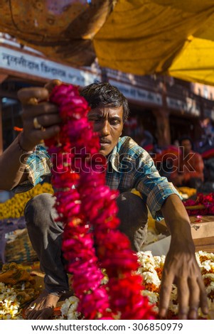 JAIPUR, INDIA-MARCH 04 :Man preparing for religious celebration on the street on March 04, 2014 in Jaipur,india