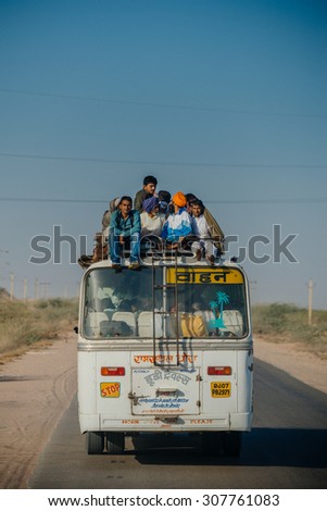 JAIPUR-MARCH 03 :people riding a bus on the street  on March 03, 2014 in Jaipur,india