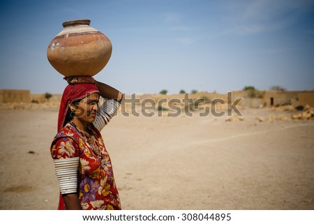JAISALMER, INDIA - MARCH 22 : Indian woman poses in the desert on March 22 , 2014 in Jaisalmer, India