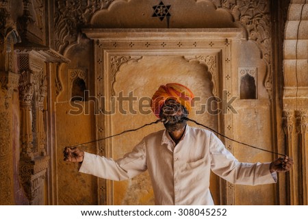 JAISALMER, INDIA - MARCH 22 : Indian man with long mustache poses in the street on March 22 , 2014 in Jaisalmer, India