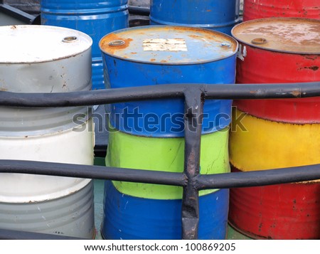 Color photograph of steel drums with gasoline