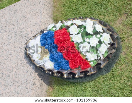 Color photograph of grave and spruce wreath