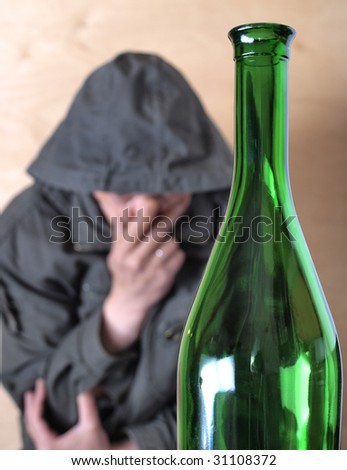 Color photo of the bottle and man. Problems with alcohol.