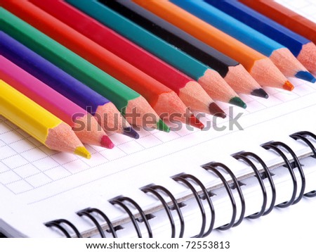 Color photo of a set of pencils on notepad
