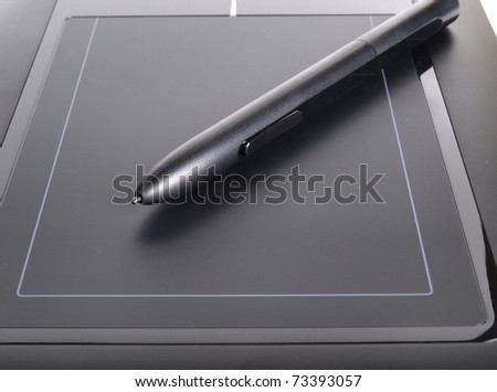 Color photo of a graphic tablet and pen