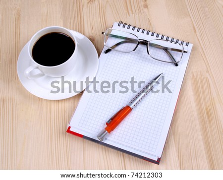 Color photo of paper page and a white cup