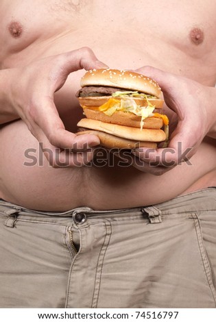 Color photo of a fat man with a hamburger in his hand